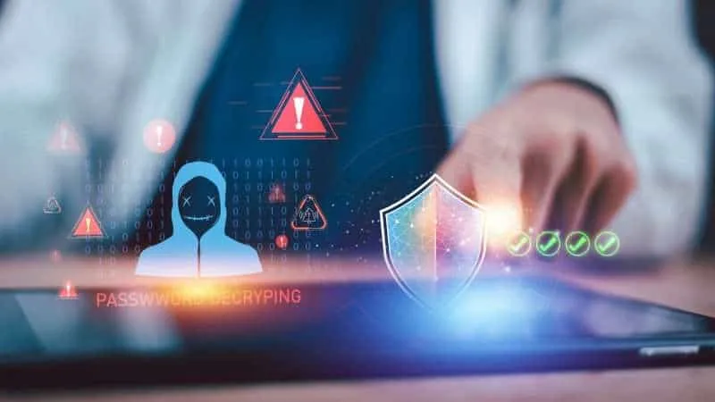 Hand tapping a tablet with a digital identity and threat protection shield icon, representing identity threat detection and response